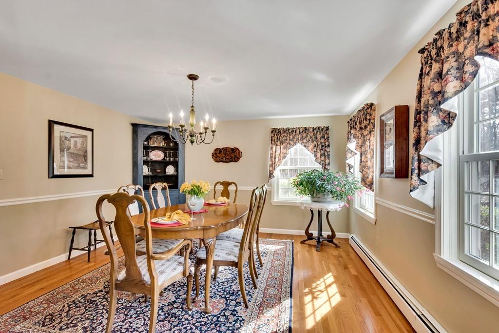 51 Parker Road Shirley, MA 01464 - Photo 18 of 39 a dining room with furniture a chandelier and wooden floor