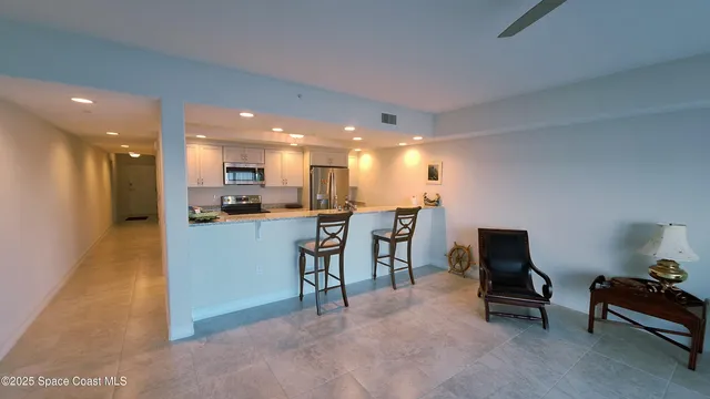 a view of a living room and entryway