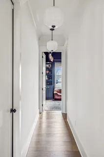 a view of a hallway with a chandelier