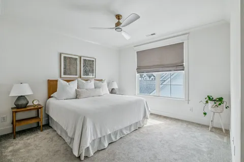 a spacious bedroom with a bed and a potted plant
