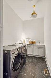 a utility room with sink dryer and washer