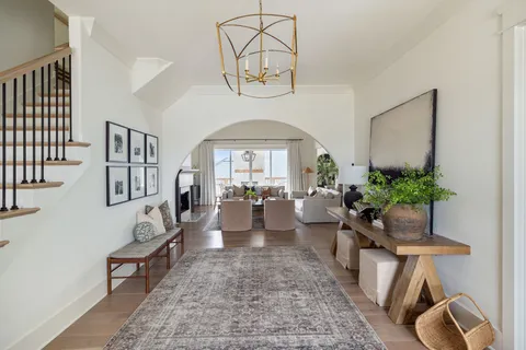a living room with furniture and a potted plant