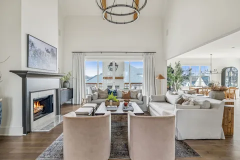 a living room with furniture a fireplace and a large window