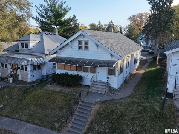 a aerial view of a house with a yard