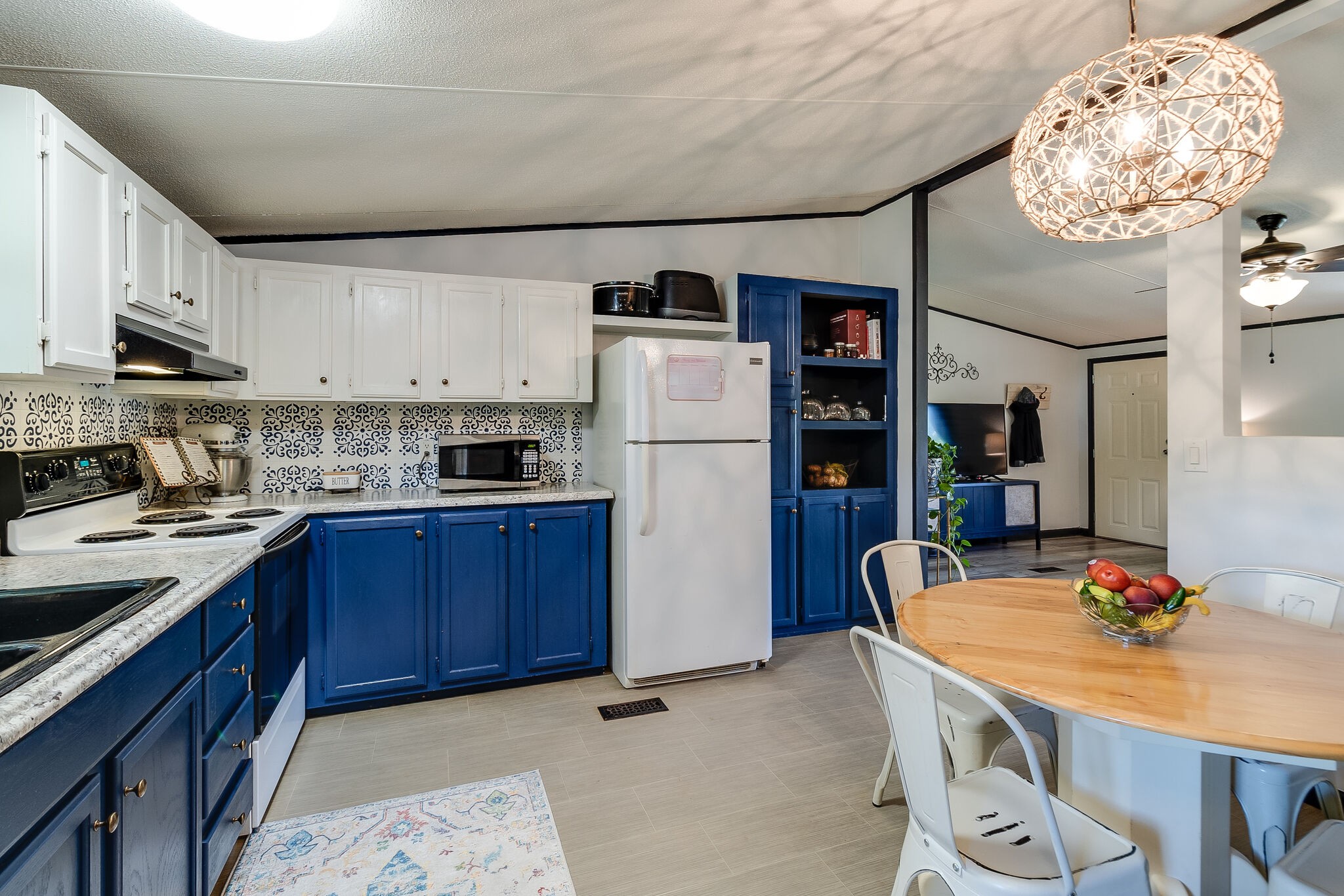 2865 Carpenter Bridge Road Columbia, TN 38401 - Photo 17 of 25 a kitchen with stainless steel appliances granite countertop a refrigerator a stove a sink dishwasher and a dining table with wooden floor