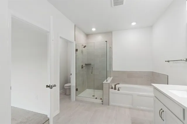 a bathroom with a bathtub and a shower