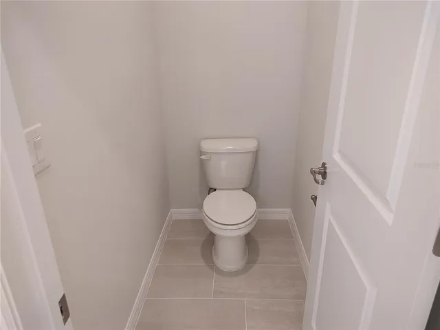 a white toilet sitting in a bathroom