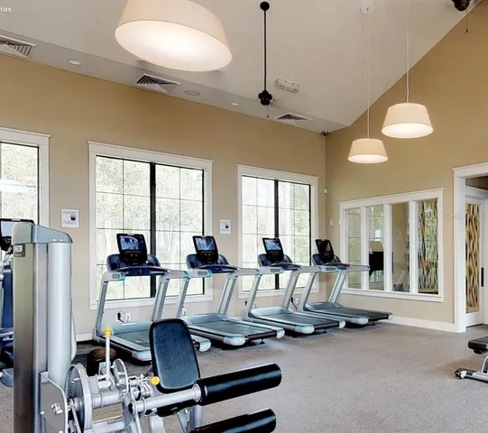 a view of a livingroom with furniture and a large window
