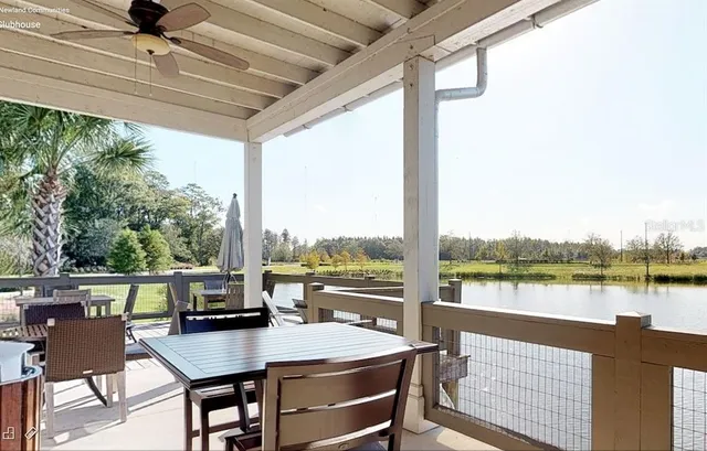 a view of a city from a dining room with a table and chairs