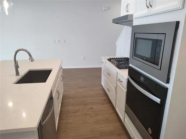 a kitchen with a stove top oven and sink