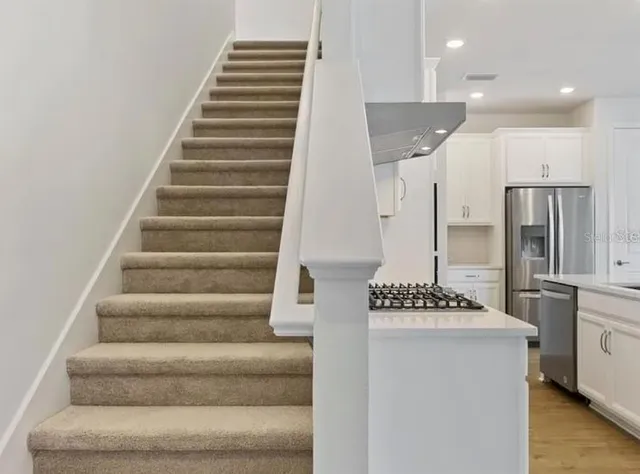 a view of entryway and hall with wooden floor