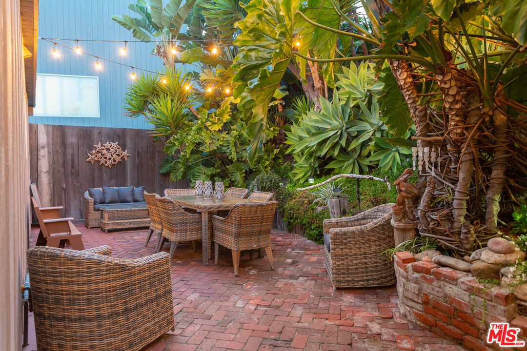 24246 Malibu Road Malibu, CA 90265 - Photo 18 of 20 a backyard of a house with barbeque oven table and chairs
