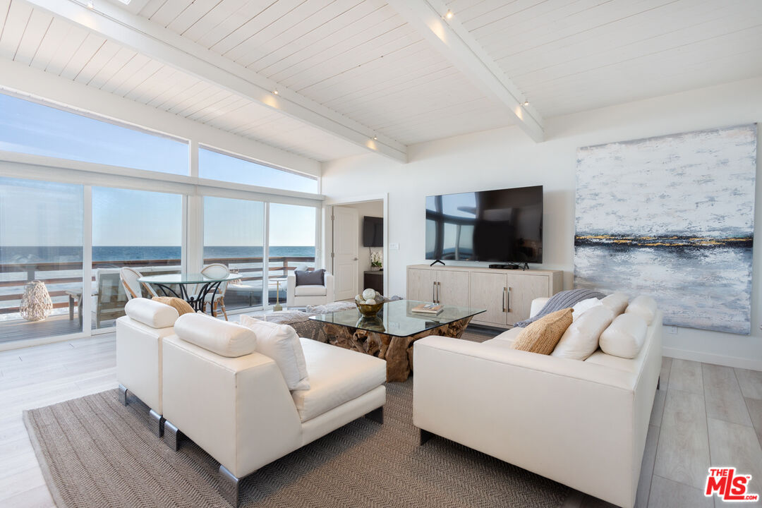 24246 Malibu Road Malibu, CA 90265 - Photo 2 of 20 a living room with furniture and a flat screen tv