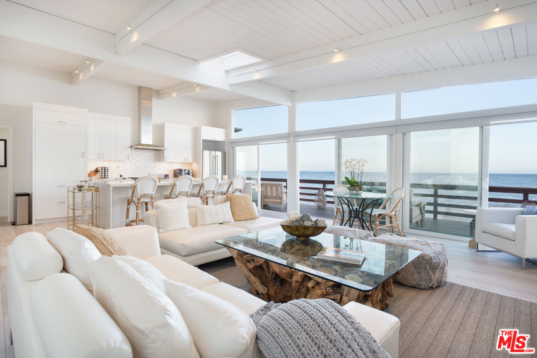 24246 Malibu Road Malibu, CA 90265 - Photo 3 of 20 a living room with furniture large windows and wooden floor