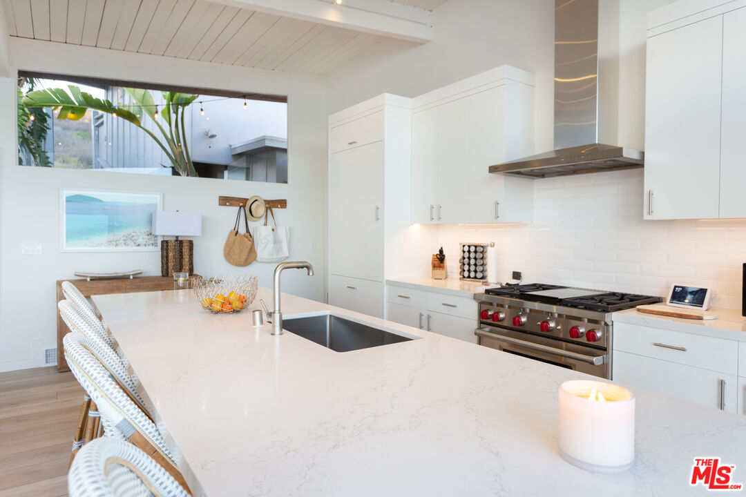 24246 Malibu Road Malibu, CA 90265 - Photo 6 of 20 a kitchen with a stove a sink and a refrigerator
