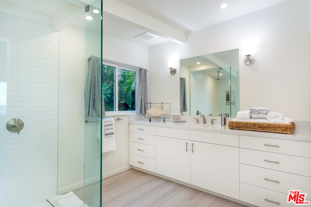 24246 Malibu Road Malibu, CA 90265 - Photo 9 of 20 a bathroom with a double vanity sink and mirror