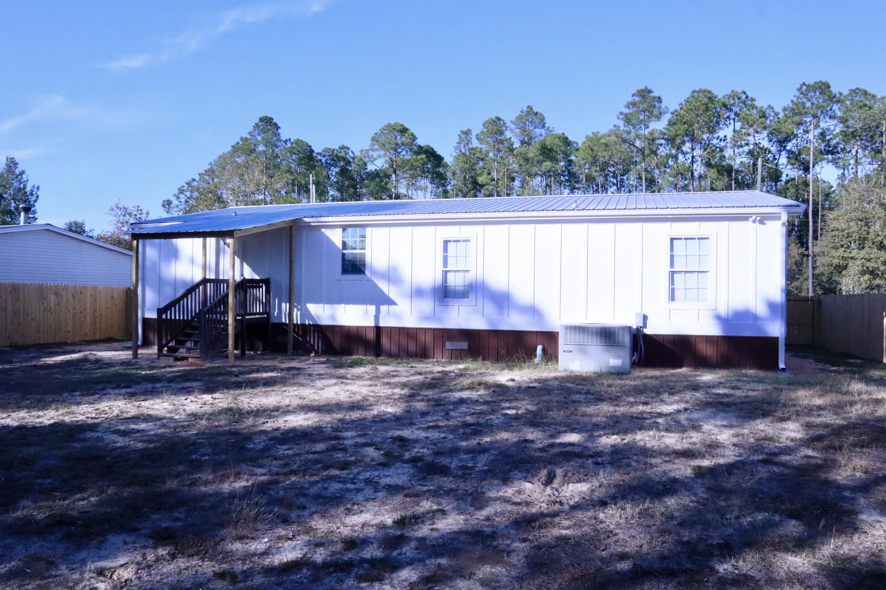 4608 Falcon Way Crestview, FL 32539 - Photo 38 of 42 a view of a house with backyard and sitting area