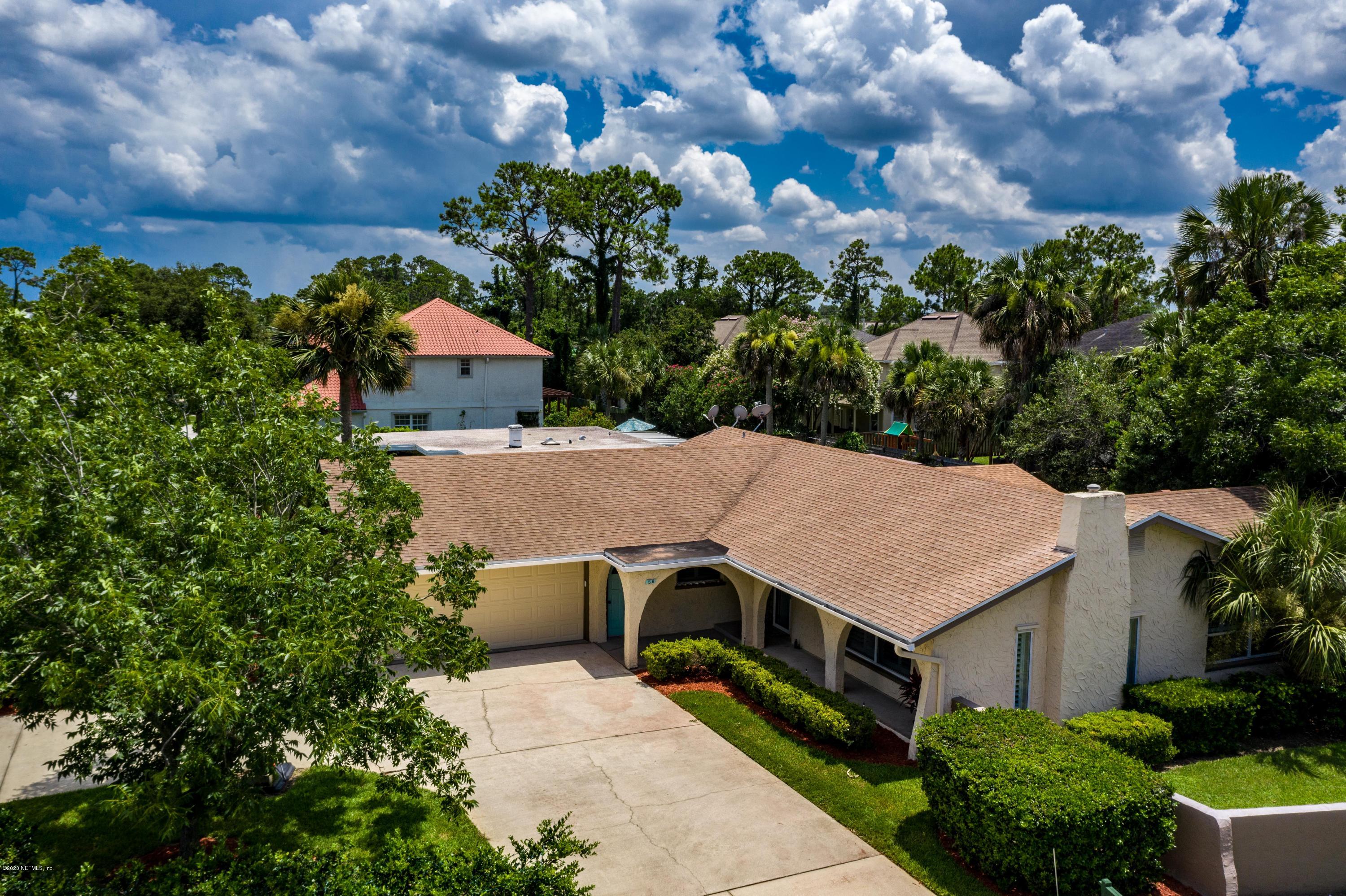 56 Solana Road Ponte Vedra Beach, FL 32082 - Photo 1 of 47 a aerial view of a house with a big yard plants and large trees