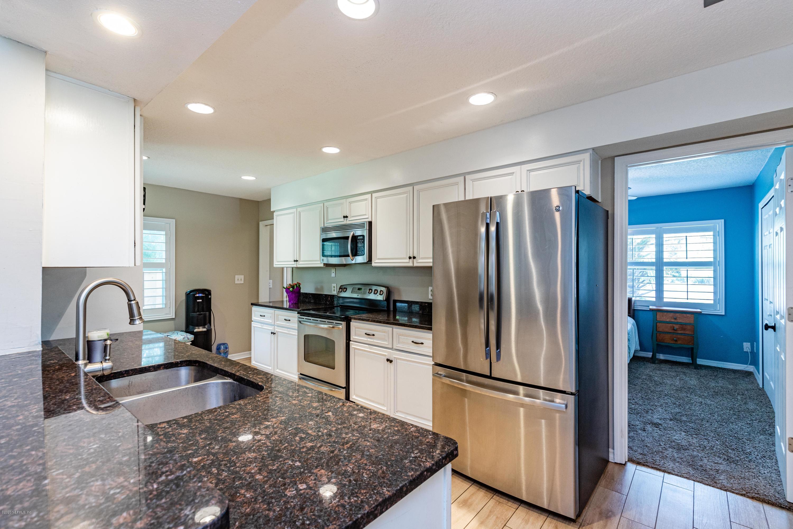 56 Solana Road Ponte Vedra Beach, FL 32082 - Photo 11 of 47 a kitchen with refrigerator and stove