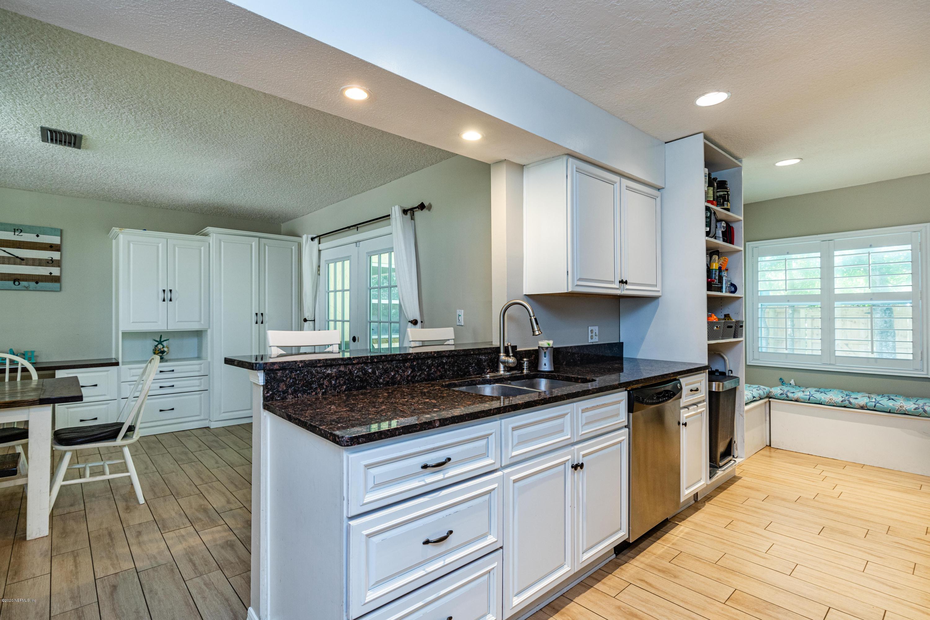 56 Solana Road Ponte Vedra Beach, FL 32082 - Photo 12 of 47 a kitchen with granite countertop a stove sink and cabinets