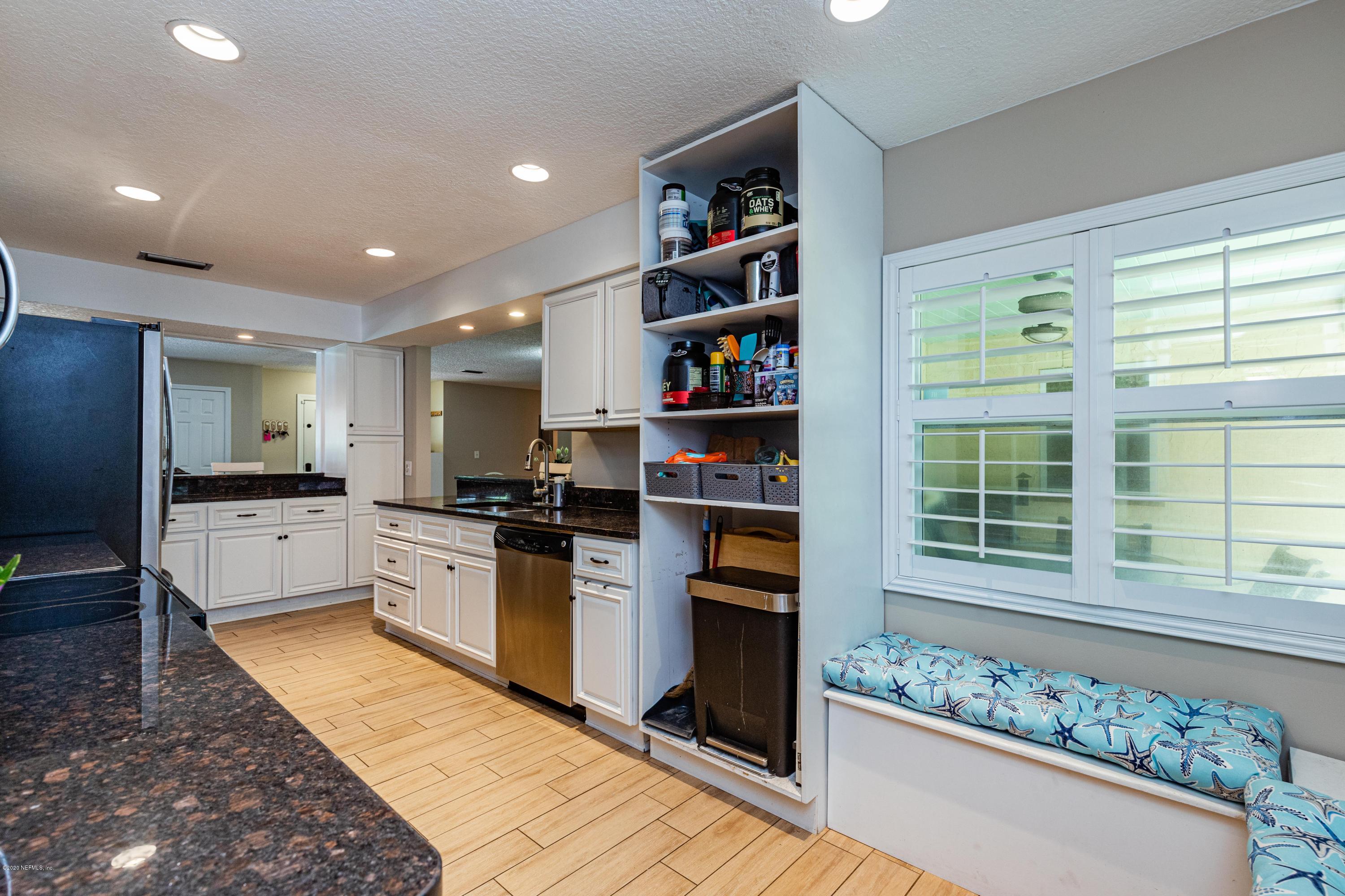 56 Solana Road Ponte Vedra Beach, FL 32082 - Photo 13 of 47 a kitchen with stainless steel appliances kitchen island granite countertop a refrigerator and a stove top oven