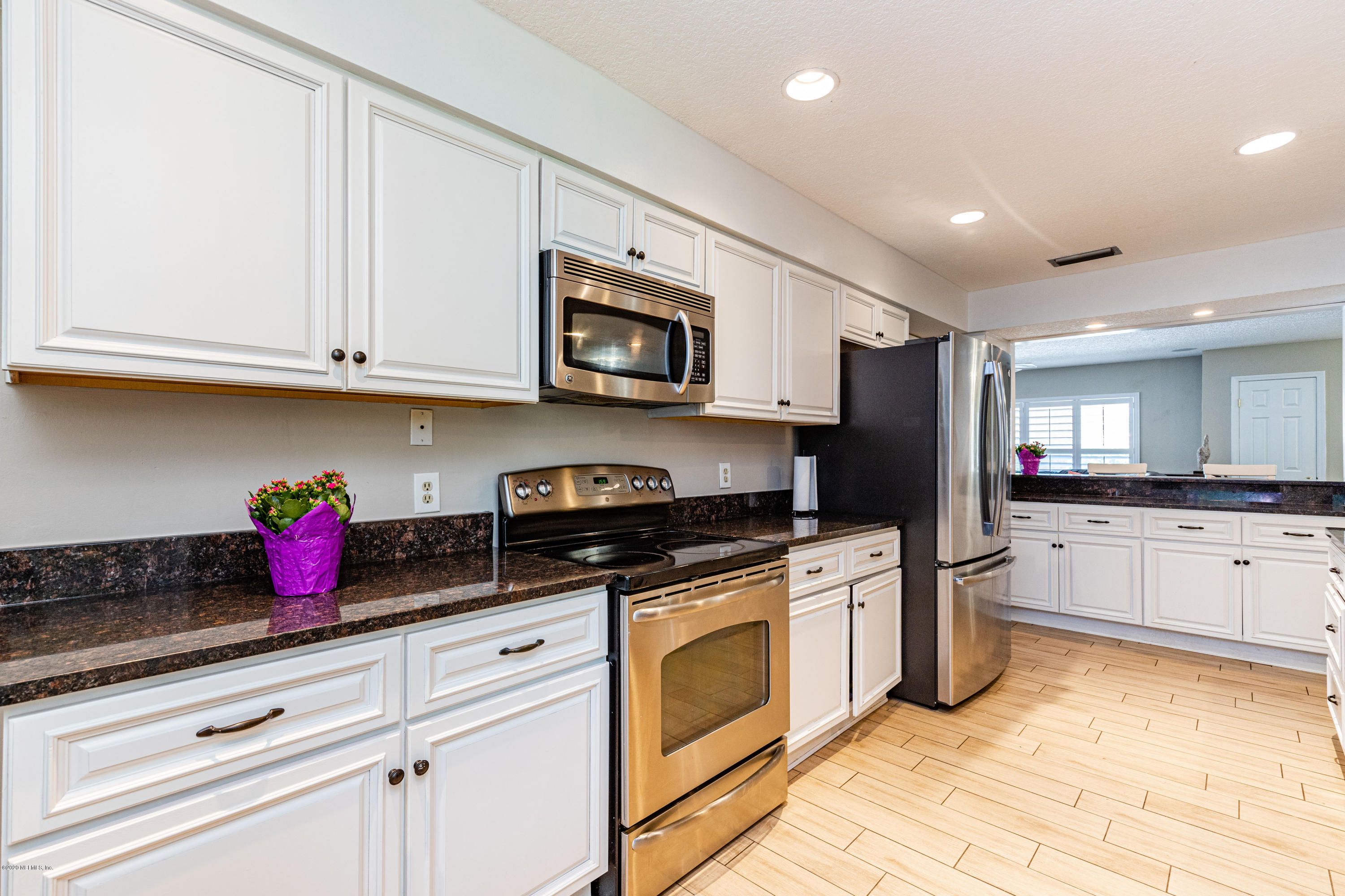 56 Solana Road Ponte Vedra Beach, FL 32082 - Photo 14 of 47 a kitchen with granite countertop cabinets stainless steel appliances and a sink