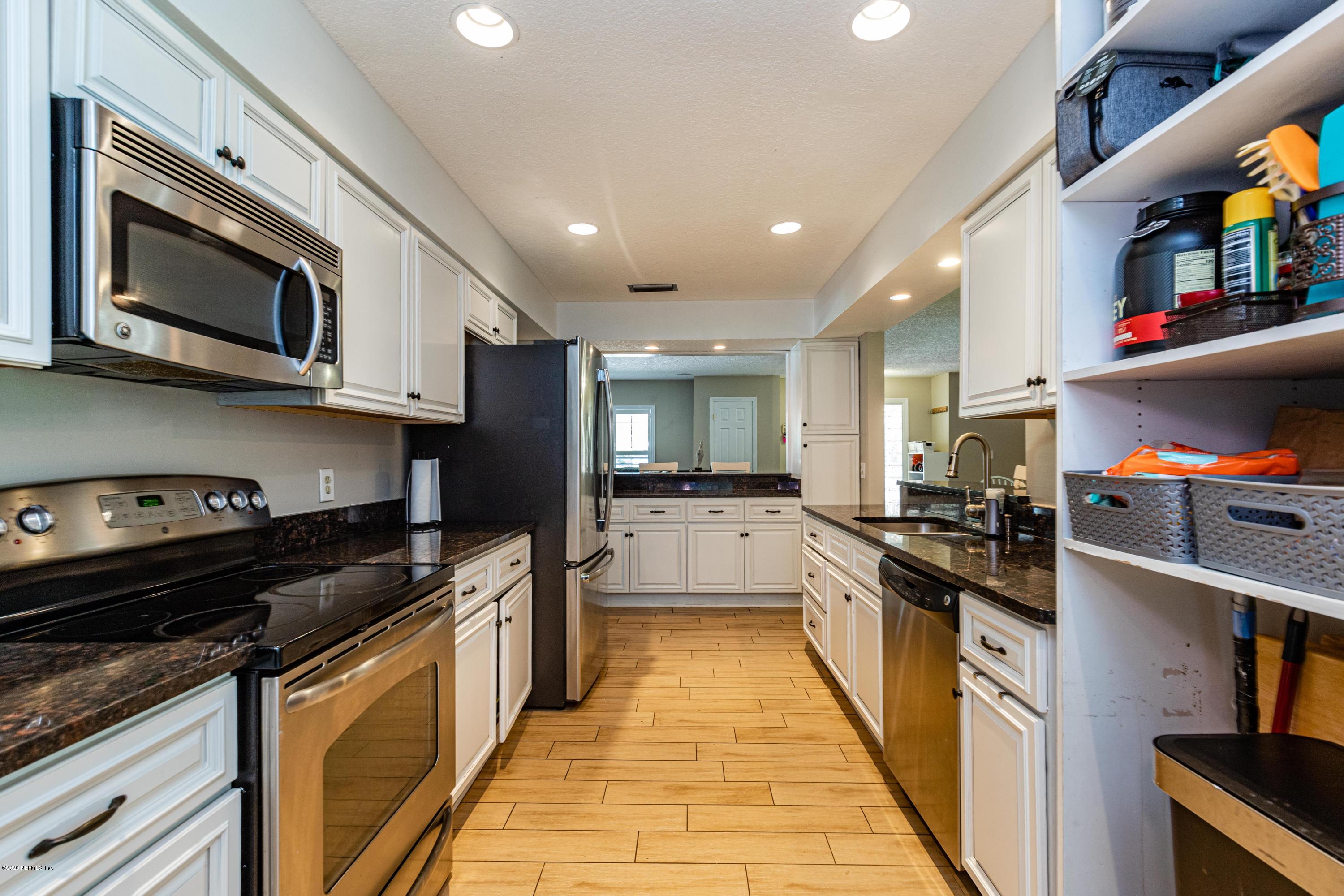 56 Solana Road Ponte Vedra Beach, FL 32082 - Photo 16 of 47 a kitchen with stainless steel appliances granite countertop a stove top oven a sink dishwasher and a microwave