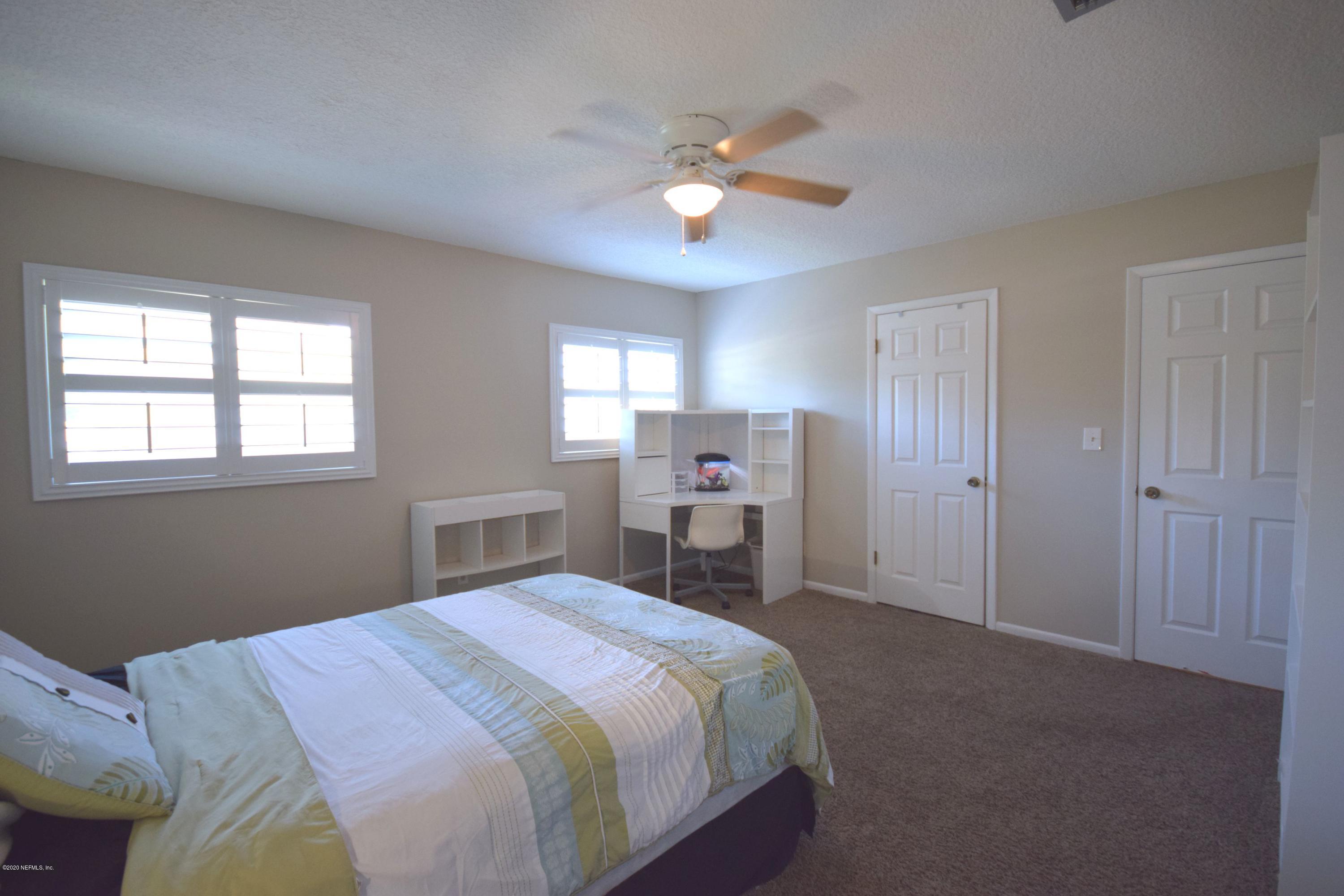 56 Solana Road Ponte Vedra Beach, FL 32082 - Photo 30 of 47 a bedroom with a bed and a chandelier