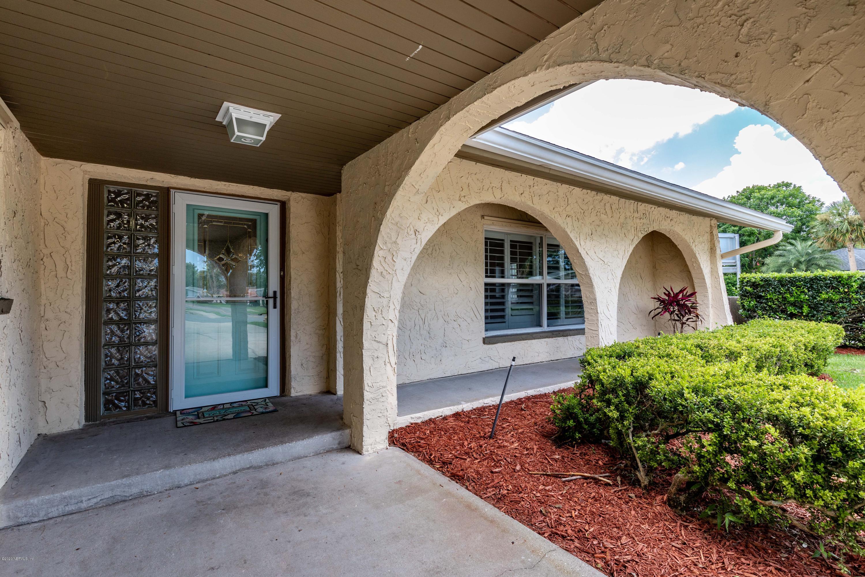 56 Solana Road Ponte Vedra Beach, FL 32082 - Photo 3 of 47 a front view of a house with garden