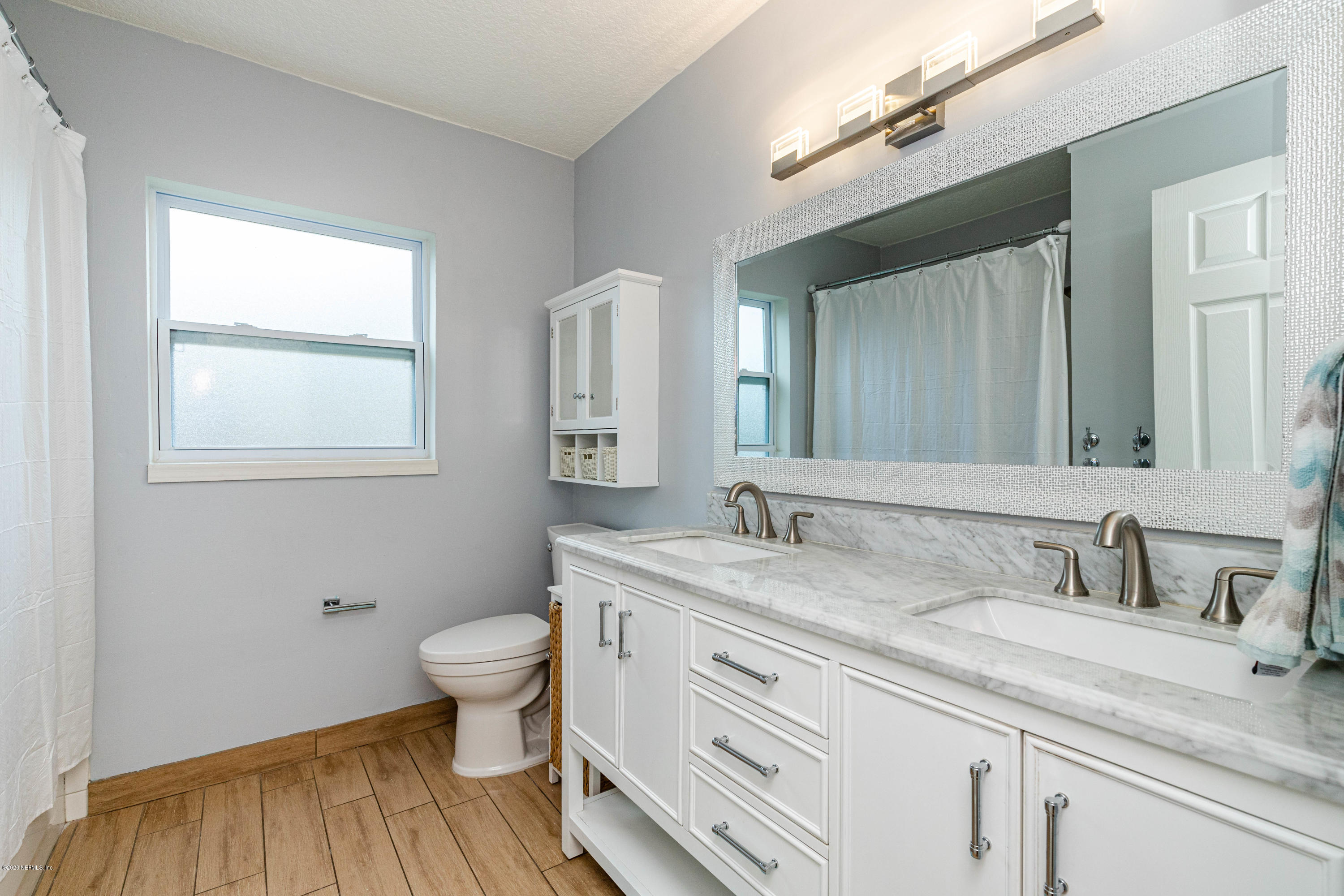 56 Solana Road Ponte Vedra Beach, FL 32082 - Photo 31 of 47 a bathroom with a granite countertop sink toilet and mirror