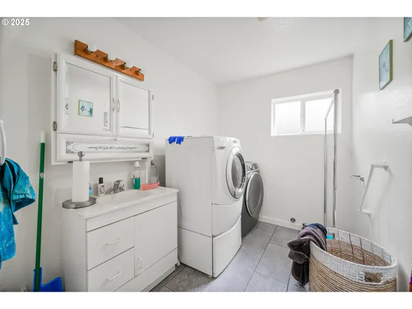 a utility room with cabinets washer and dryer