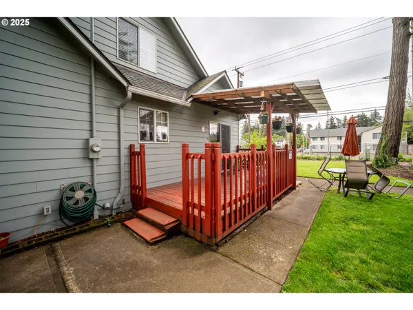 a view of a porch with furniture and a yard