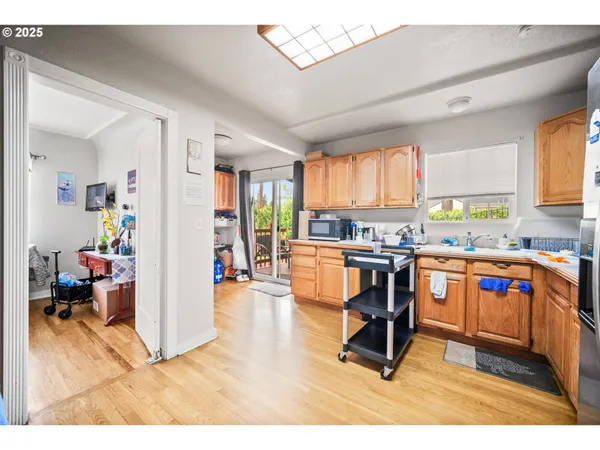 a living room with stainless steel appliances kitchen island granite countertop lots of counter top space