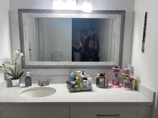 a bathroom with sink and a mirror