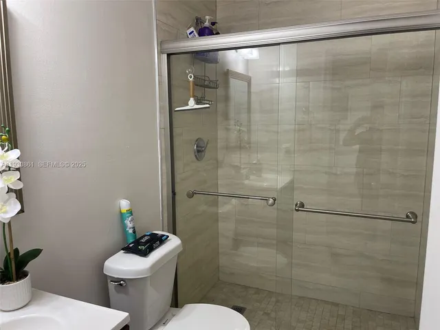 a bathroom with a toilet and a shower