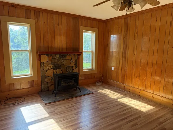 a view of a room with wooden floor and furniture