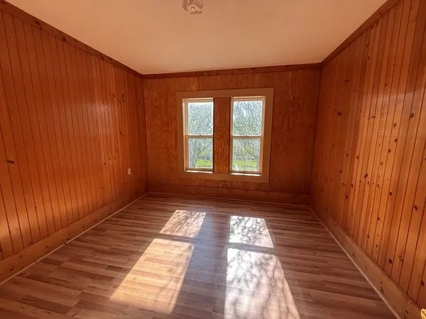a view of a room with wooden floor and staircase