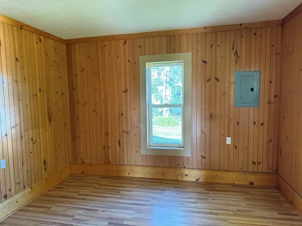 an empty room with wooden floor