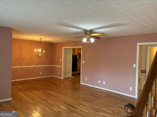 a view of a livingroom with wooden floor and a window