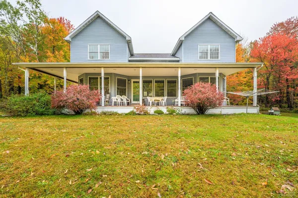 a front view of house with an outdoor space and seating