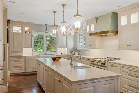 a kitchen with stainless steel appliances a sink stove and cabinets