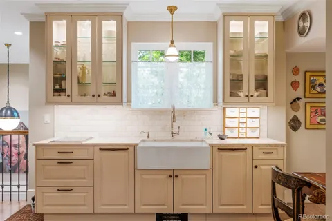 a kitchen with a sink window and cabinets