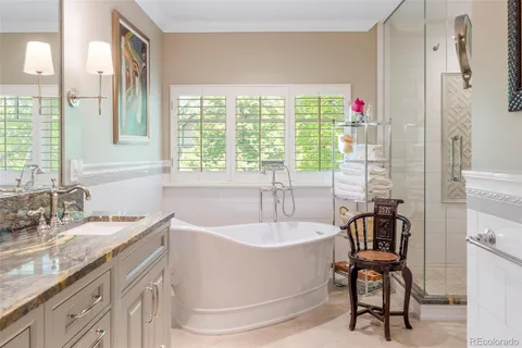 a bathroom with a granite countertop sink and a bathtub
