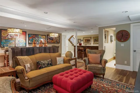 a living room with furniture a rug and a large window