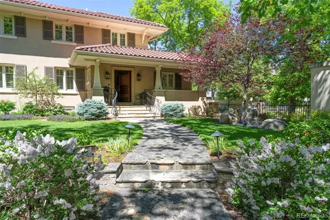 a front view of a house with garden and porch