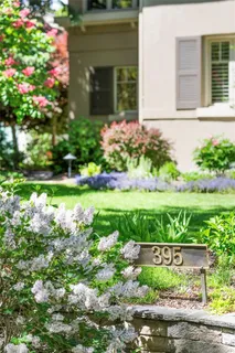 a front view of a house with a yard and flowers