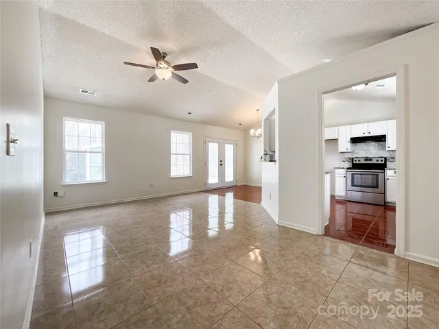 a view of a livingroom with a furniture ceiling fan and window