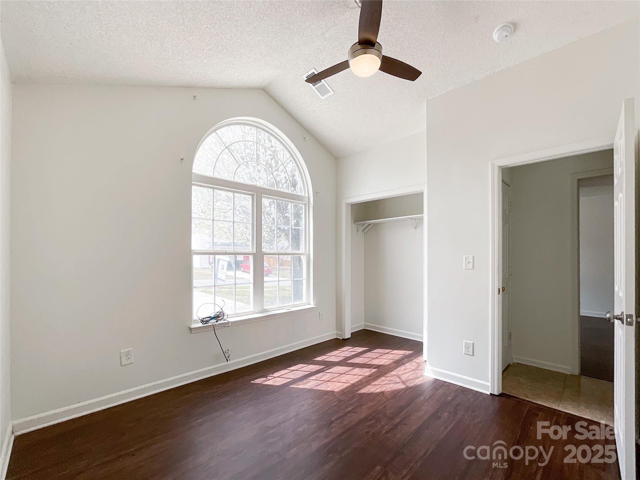5610 Stone Bluff Court Charlotte, NC 28214 - Photo 18 of 41 an empty room with wooden floor cabinet and windows
