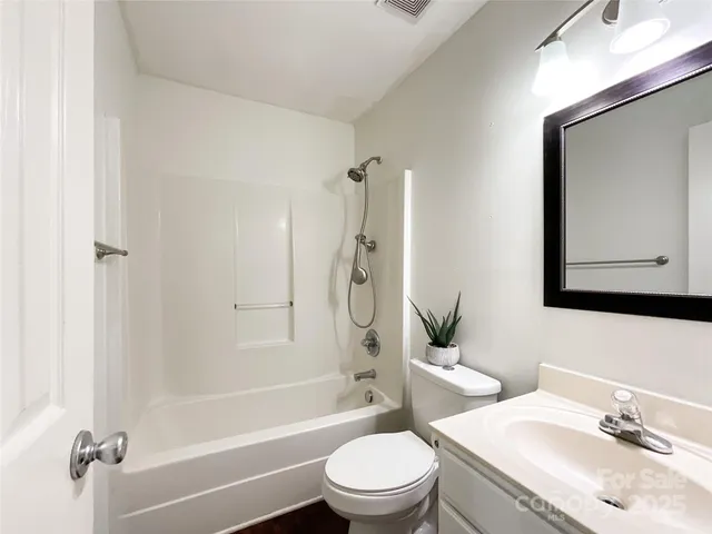 a bathroom with a toilet a sink and a mirror