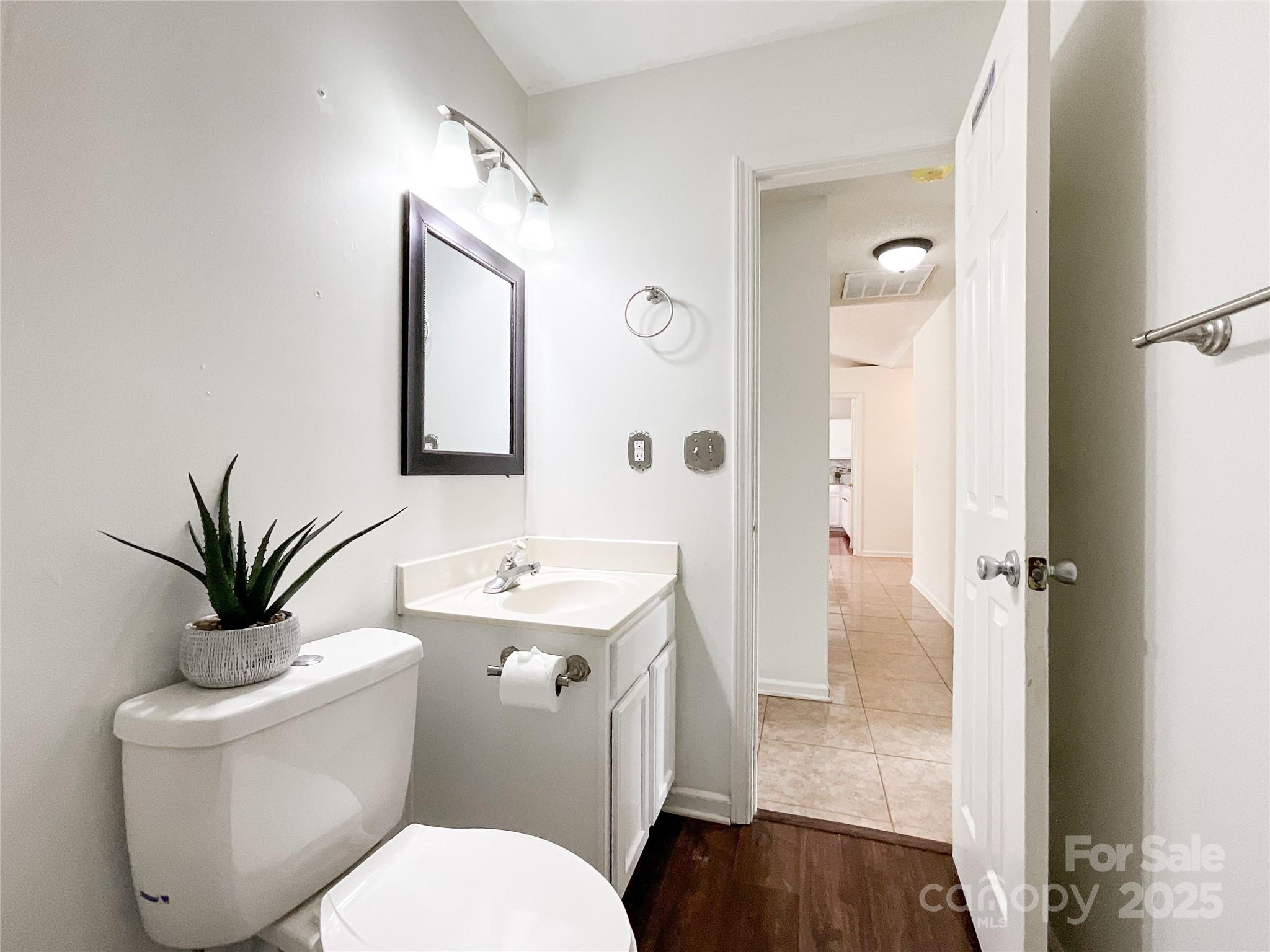 5610 Stone Bluff Court Charlotte, NC 28214 - Photo 23 of 41 a bathroom with a toilet a sink and a mirror